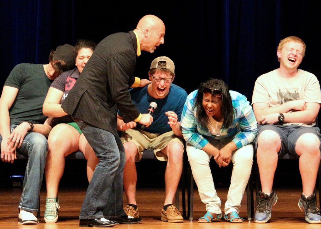 Hypnotist performs Comedy Stage Hypnosis Show for college audience.